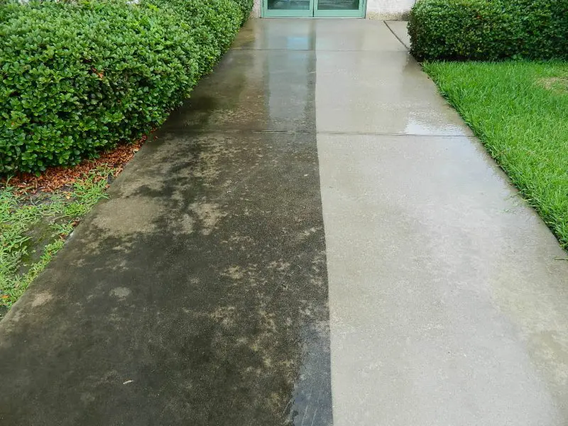A concrete walkway with half of it washed to display the difference