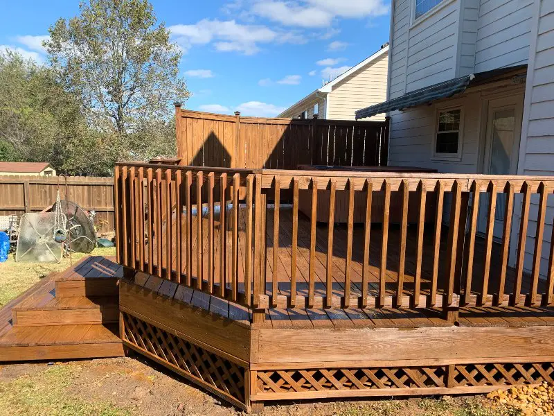 A wooden deck with stairs and railings that has been professionally washed