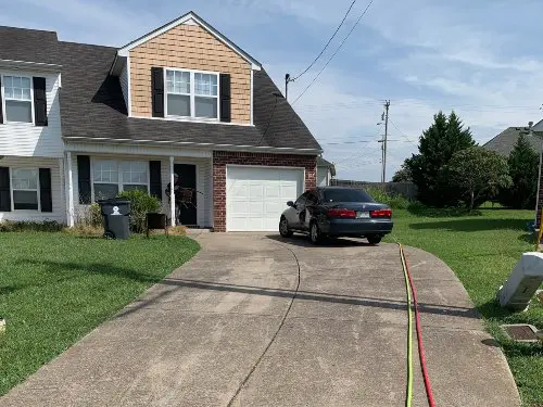 A dirty concrete driveway before being cleaned and sealed